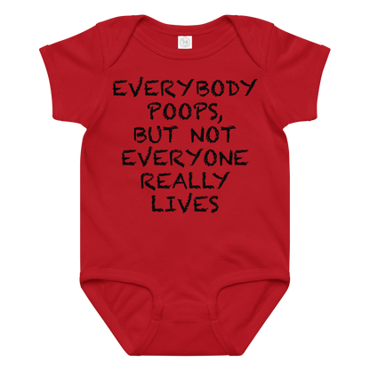 "Everybody poops, but not everyone really lives" printed on a red baby jersey bodysuit laying on a flat surface amongst other clothes
