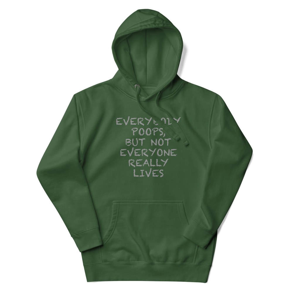 "Everybody poops, but not everyone really lives" printed on a forest green unisex hoodie laying on a flat surface with the hood up