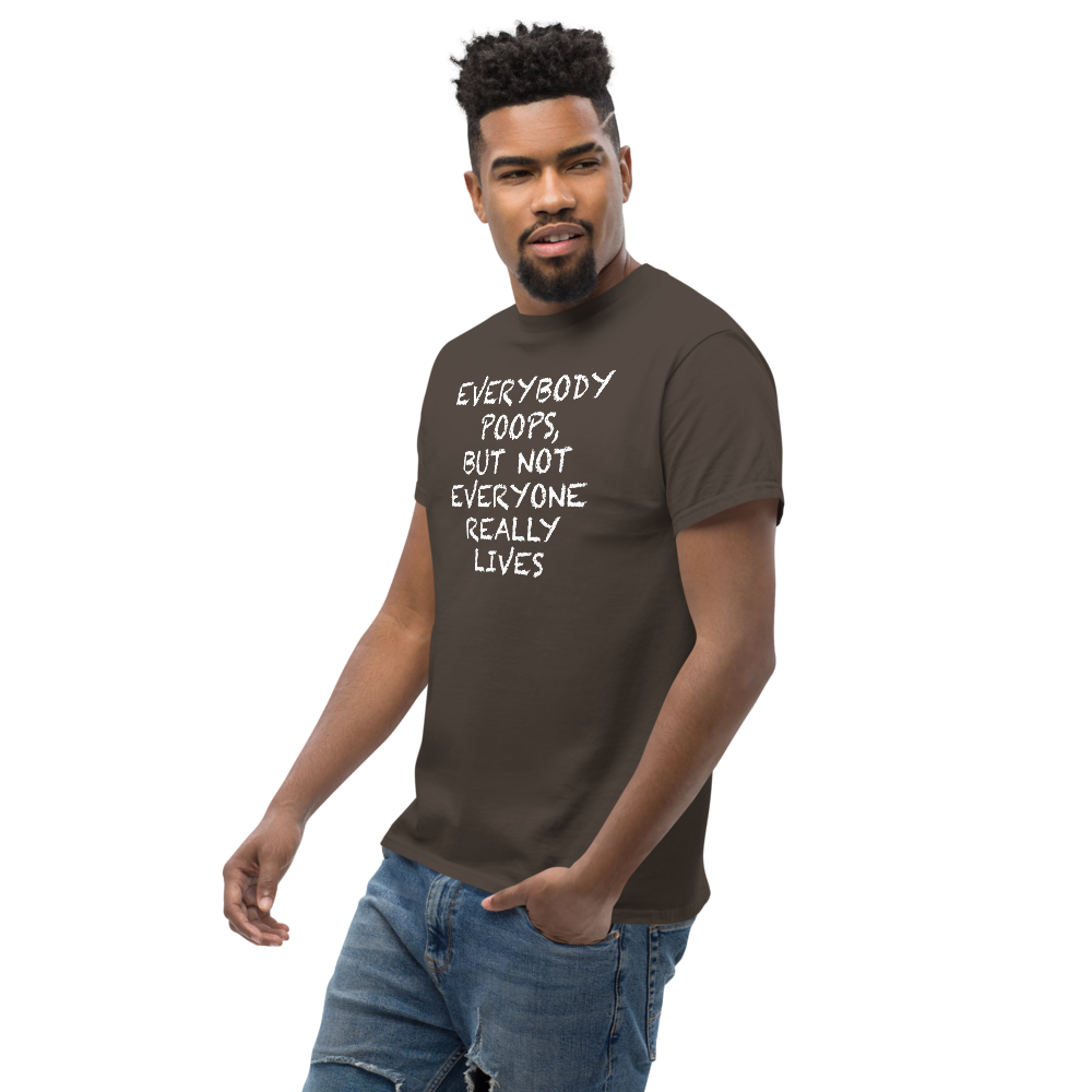 "Everybody poops, but not everyone really lives" printed on a dark chocolate unisex classic tee worn by a male