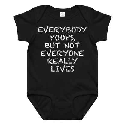 "Everybody poops, but not everyone really lives" printed on a black baby jersey bodysuit laying on a flat surface amongst other clothes