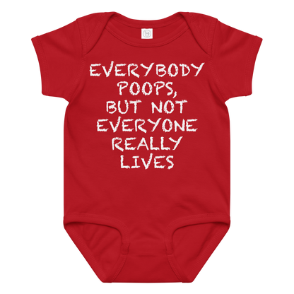 "Everybody poops, but not everyone really lives" printed on a red baby jersey bodysuit laying on a flat surface amongst other clothes