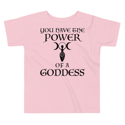 "You have the power of a goddess" printed on a pink toddler short sleeve tee laying on a flat surface