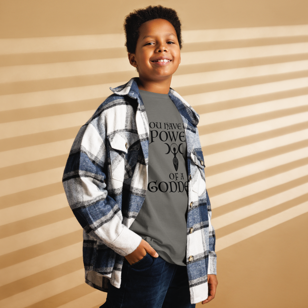 "You have the power of a goddess" printed on a charcoal youth classic tee worn by a male also wearing a jacket