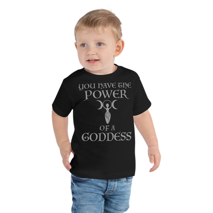 "You have the power of a goddess" printed on a black toddler short sleeve tee worn by a male