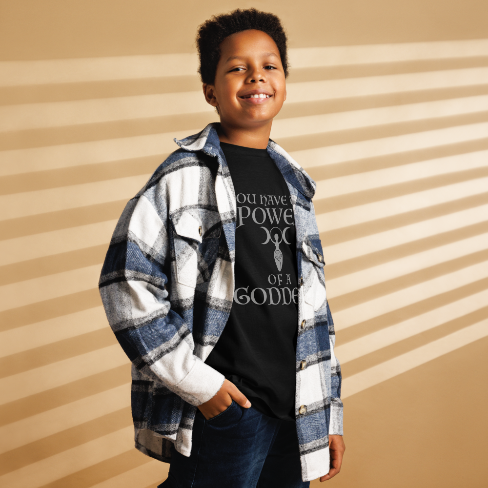 "You have the power of a goddess" printed on a black youth classic tee worn by a male also wearing a jacket