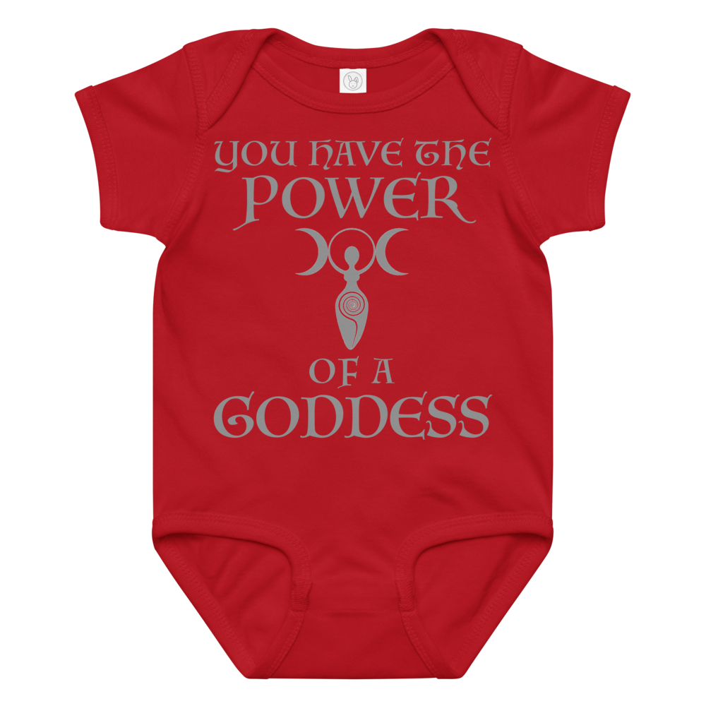 "You have the power of a goddess" printed on a red baby jersey bodysuit laying on a flat surface amongst other clothes