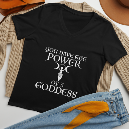 "You have the power of a goddess" printed on a solid black blend women's relaxed v-neck t-shirt laying on a flat surface amongst other clothes