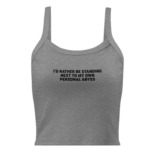"I'd rather be standing next to my own personal abyss" printed on a athletic heather women's micro-rib tanktop laying on a flat surface