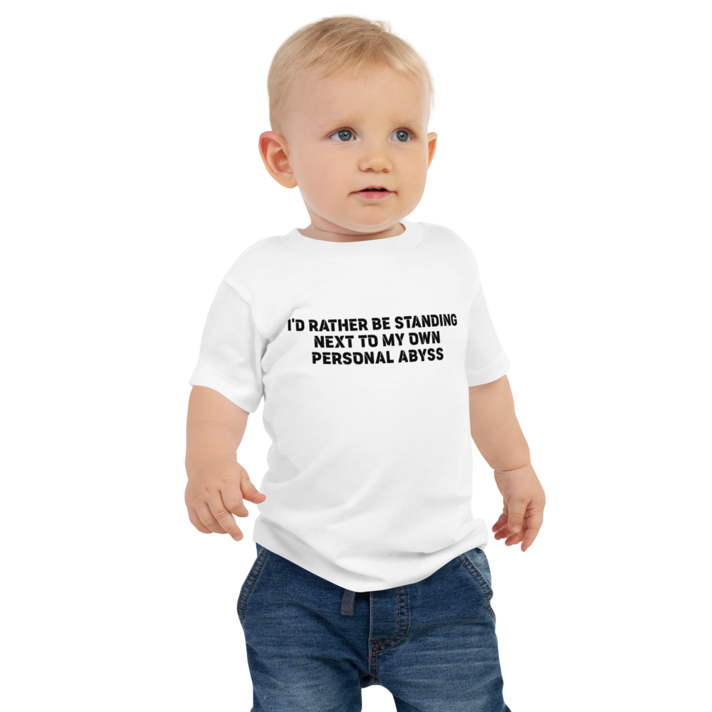 "I'd rather be standing next to my own personal abyss" printed on a white baby jersey short sleeve tee worn by a male