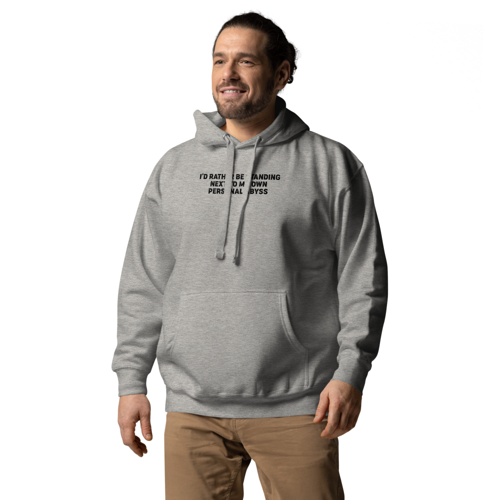 "I'd rather be standing next to my own personal abyss" printed on a carbon grey unisex hoodie worn by a male