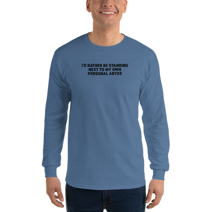 "I'd rather be standing next to my own personal abyss" printed on a indigo blue men's long sleeve shirt worn by a male