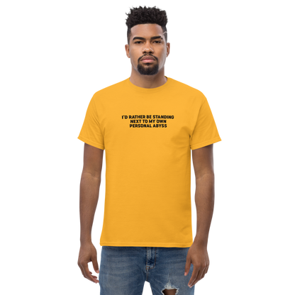 "I'd rather be standing next to my own personal abyss" printed on a gold unisex classic tee worn by a male
