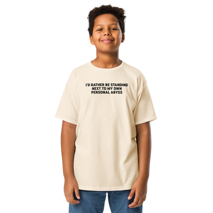 "I'd rather be standing next to my own personal abyss" printed on a natural youth classic tee worn by a male