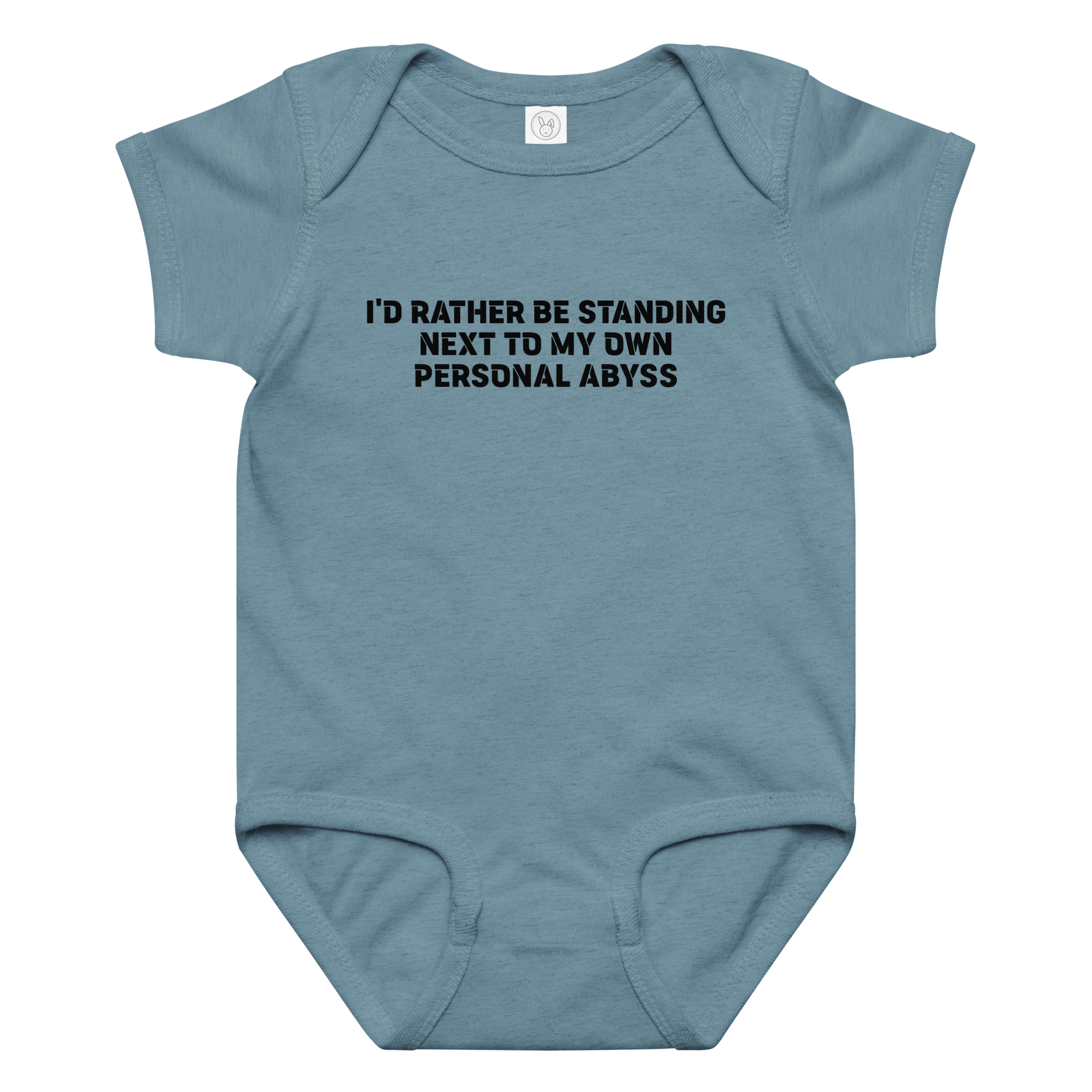 "I'd rather be standing next to my own personal abyss" printed on a vintage indigo baby jersey bodysuit laying on a flat surface amongst other clothes