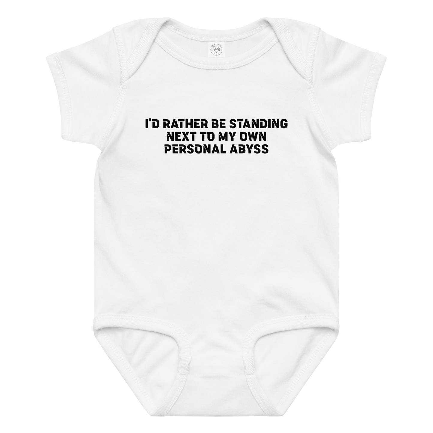 "I'd rather be standing next to my own personal abyss" printed on a white baby jersey bodysuit laying on a flat surface amongst other clothes