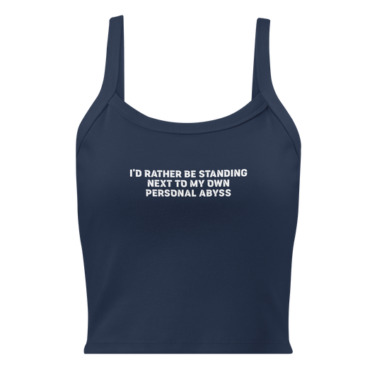 "I'd rather be standing next to my own personal abyss" printed on a solid navy blend women's micro-rib tanktop laying on a flat surface