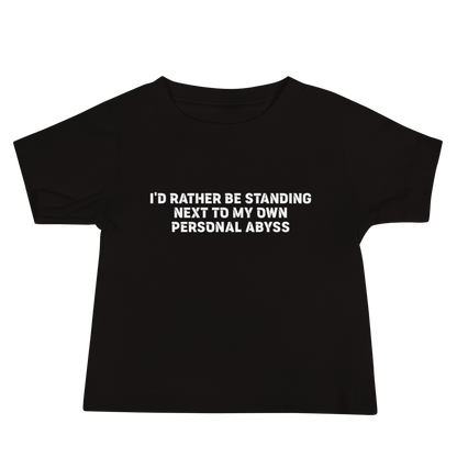 "I'd rather be standing next to my own personal abyss" printed on a black baby jersey short sleeve tee laying on a flat surface