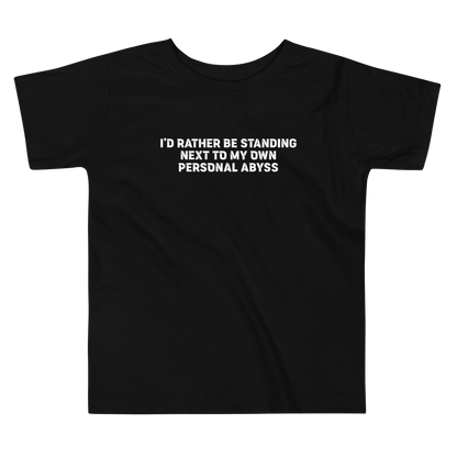 "I'd rather be standing next to my own personal abyss" printed on a black toddler short sleeve tee laying on a flat surface