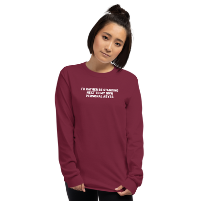 "I'd rather be standing next to my own personal abyss" printed on a maroon men's long sleeve shirt worn by a female