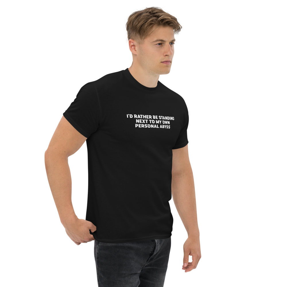 "I'd rather be standing next to my own personal abyss" printed on a black unisex classic tee worn by a male