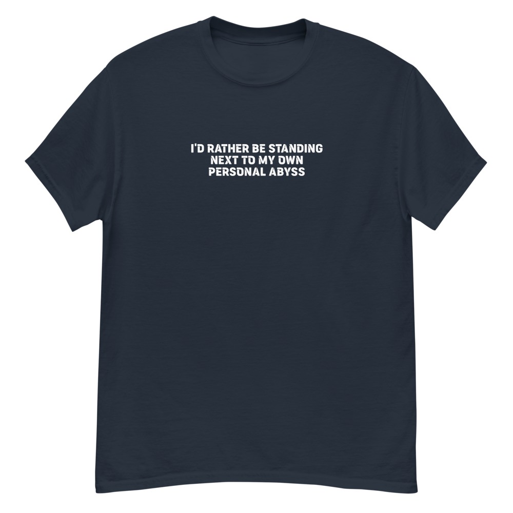 "I'd rather be standing next to my own personal abyss" printed on a navy unisex classic tee laying on a flat surface