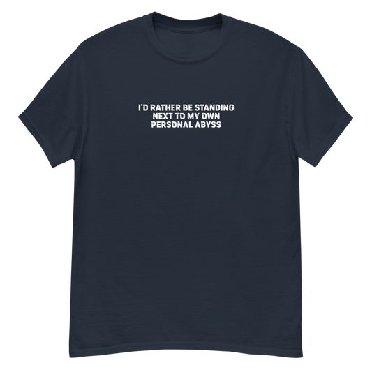 "I'd rather be standing next to my own personal abyss" printed on a navy unisex classic tee laying on a flat surface