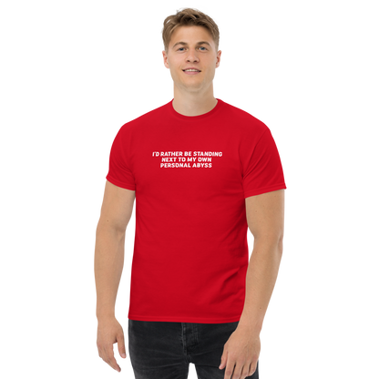 "I'd rather be standing next to my own personal abyss" printed on a red unisex classic tee worn by a male