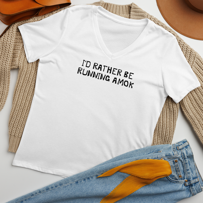 "I’d rather be running amok" printed on a solid white blend women's relaxed v-neck t-shirt laying on a flat surface amongst other clothes