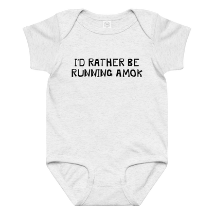 "I’d rather be running amok" printed on a ash baby jersey bodysuit laying on a flat surface amongst other clothes