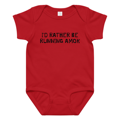 "I’d rather be running amok" printed on a red baby jersey bodysuit laying on a flat surface amongst other clothes