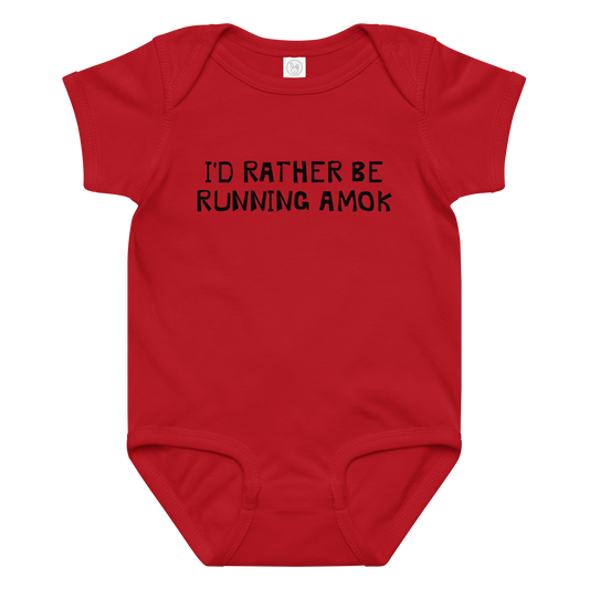 "I’d rather be running amok" printed on a red baby jersey bodysuit laying on a flat surface amongst other clothes