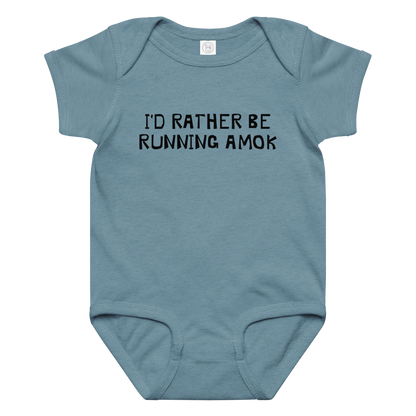 "I’d rather be running amok" printed on a vintage indigo baby jersey bodysuit laying on a flat surface amongst other clothes
