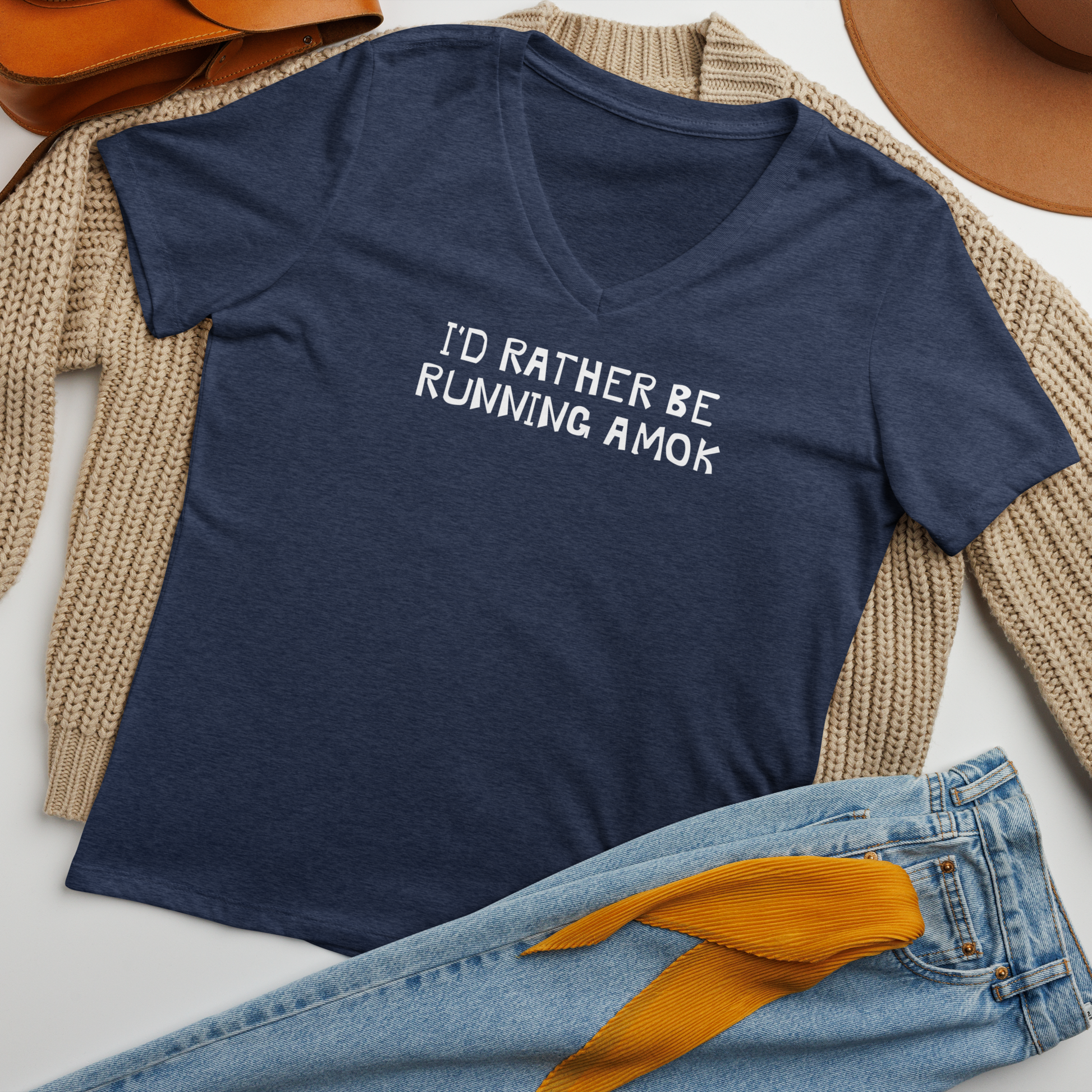 "I’d rather be running amok" printed on a heather navy women's relaxed v-neck t-shirt laying on a flat surface amongst other clothes