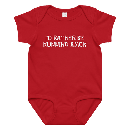 "I’d rather be running amok" printed on a red baby jersey bodysuit laying on a flat surface amongst other clothes