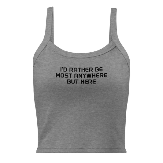 "I’d rather be most anywhere but here" printed on a athletic heather women's micro-rib tanktop laying on a flat surface