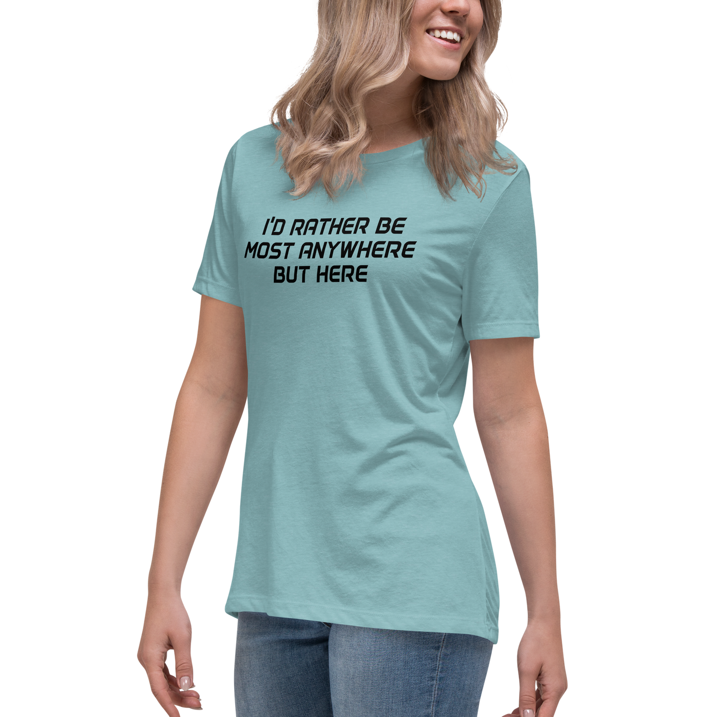 "I’d rather be most anywhere but here" printed on a heather blue lagoon women's relaxed t-shirt worn by a female