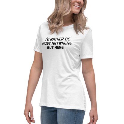 "I’d rather be most anywhere but here" printed on a white women's relaxed t-shirt worn by a female
