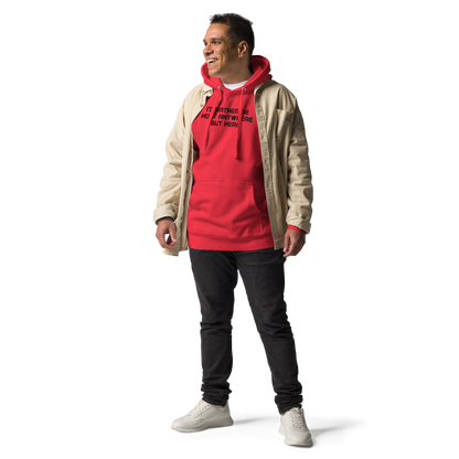 "I’d rather be most anywhere but here" printed on a team red unisex hoodie worn by a male with a jacket on top