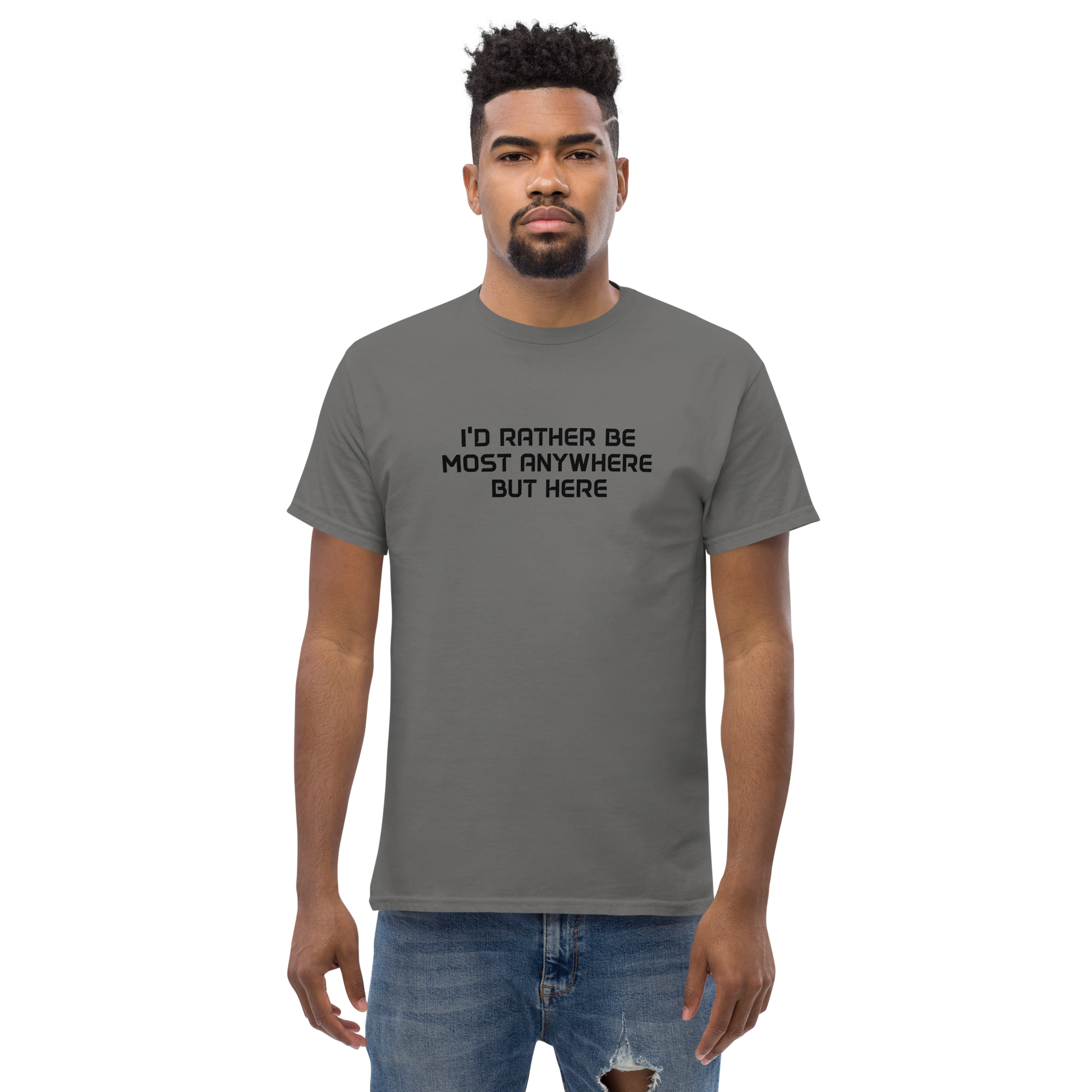 "I’d rather be most anywhere but here" printed on a charcoal unisex classic tee worn by a male