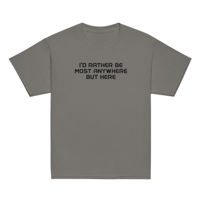 "I’d rather be most anywhere but here" printed on a charcoal youth classic tee laying on a flat surface