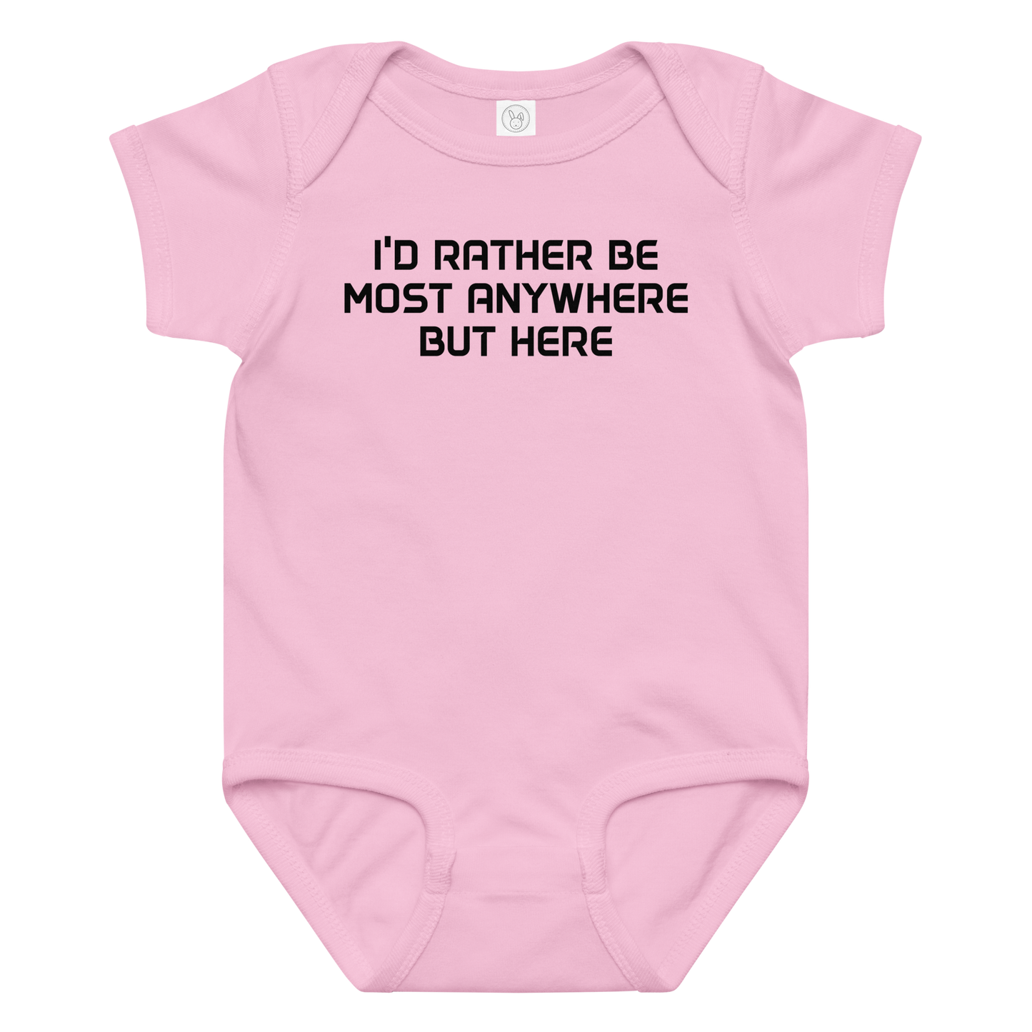 "I’d rather be most anywhere but here" printed on a pink baby jersey bodysuit laying on a flat surface amongst other clothes