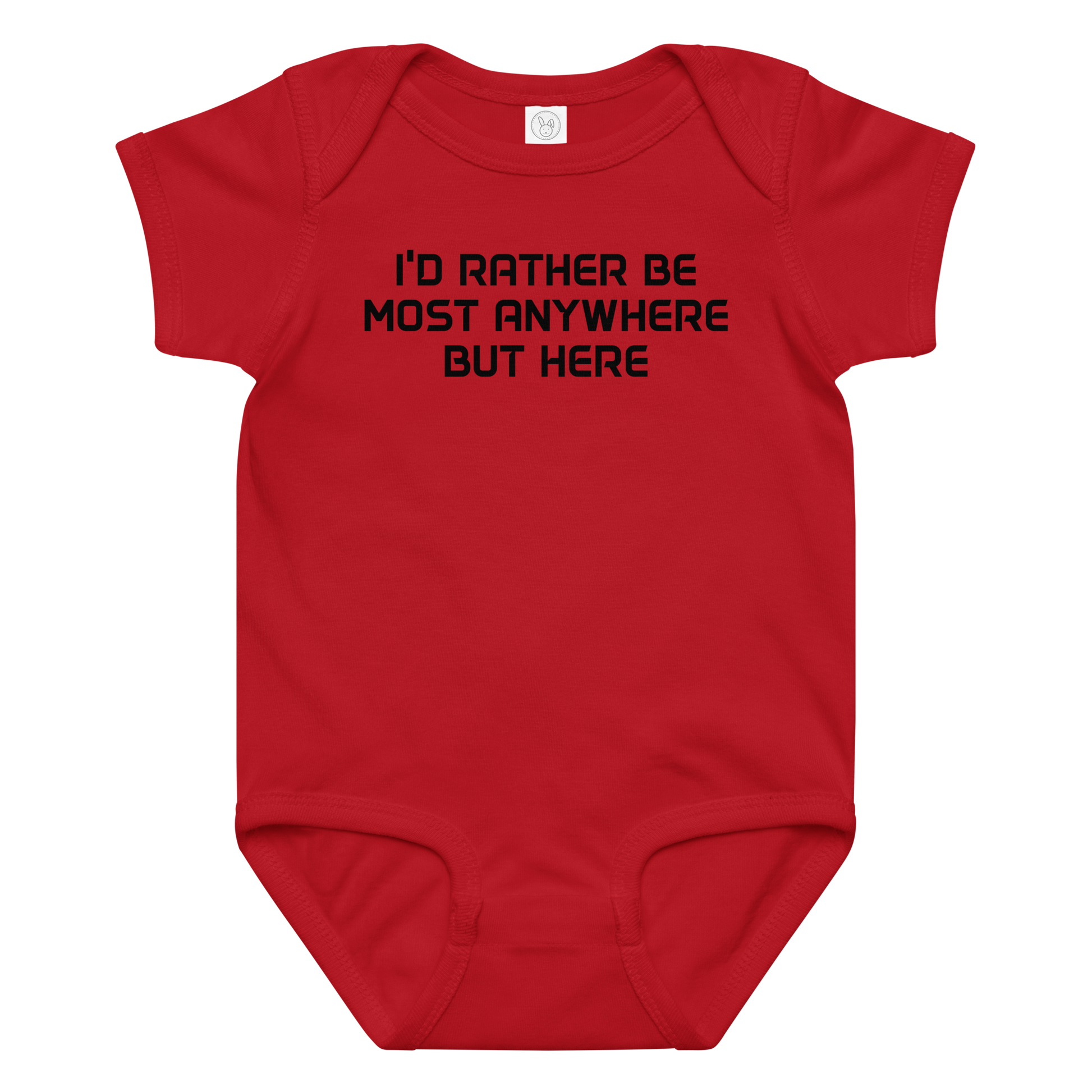 "I’d rather be most anywhere but here" printed on a red baby jersey bodysuit laying on a flat surface amongst other clothes