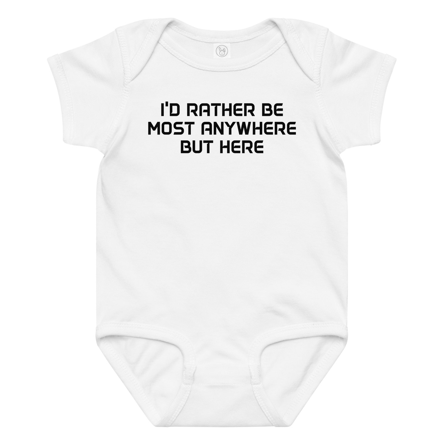 "I’d rather be most anywhere but here" printed on a white baby jersey bodysuit laying on a flat surface amongst other clothes