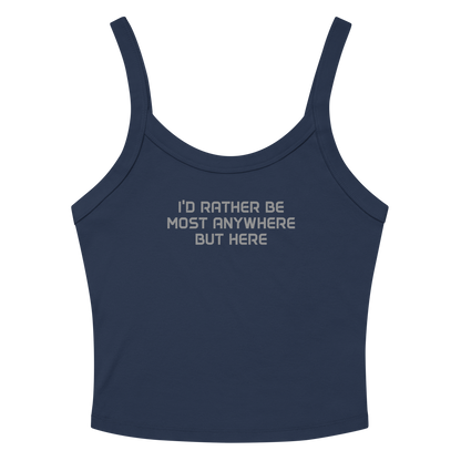 "I’d rather be most anywhere but here" printed on a solid navy blend women's micro-rib tanktop laying on a flat surface amongst sunglasses and shorts