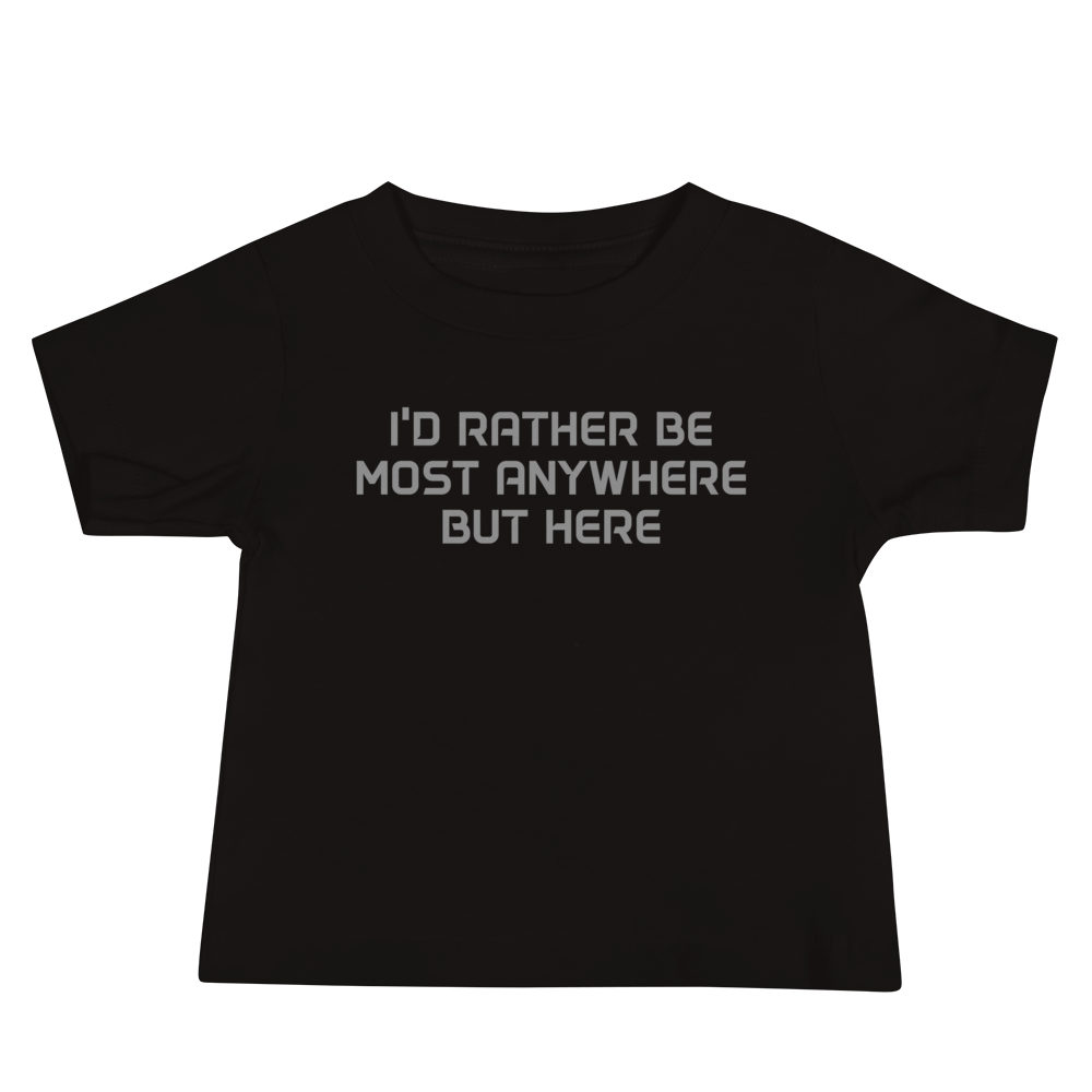 "I’d rather be most anywhere but here" printed on a black baby jersey short sleeve tee laying on a flat surface