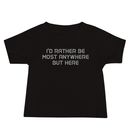 "I’d rather be most anywhere but here" printed on a black baby jersey short sleeve tee laying on a flat surface