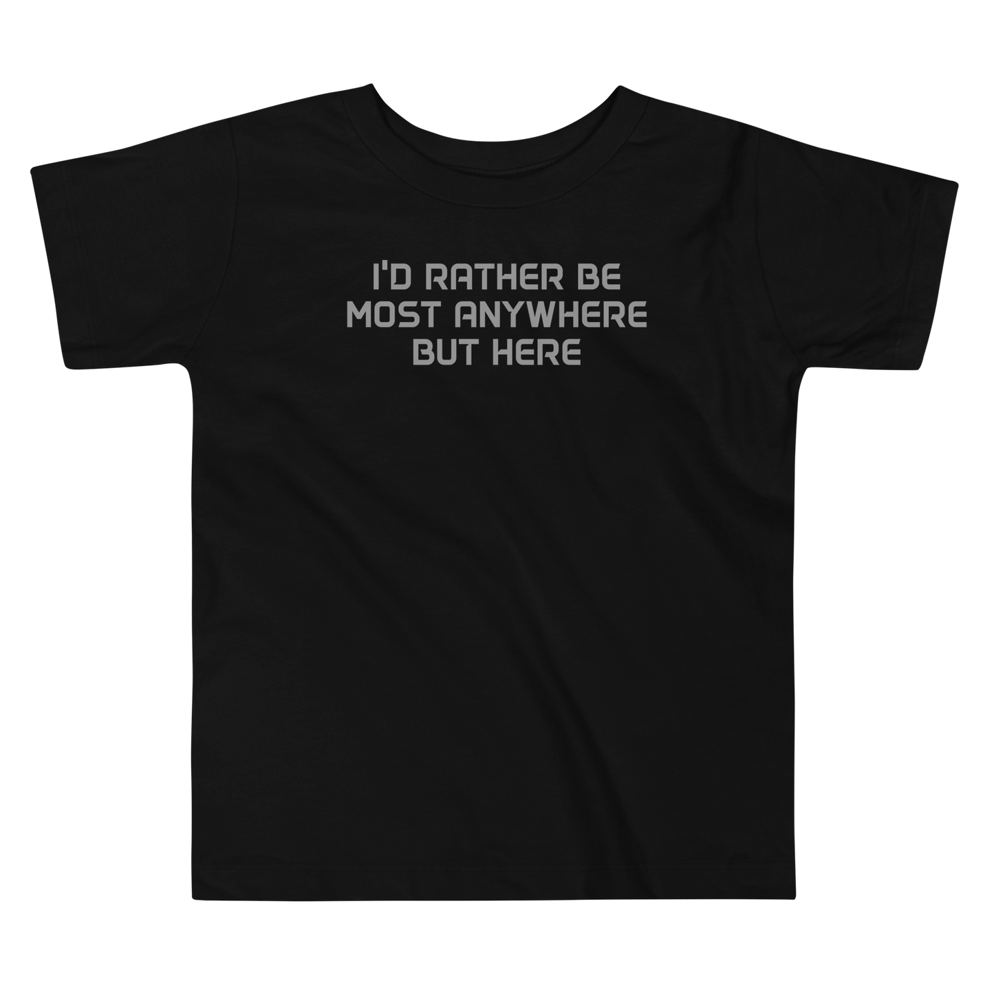 "I’d rather be most anywhere but here" printed on a black toddler short sleeve tee laying on a flat surface