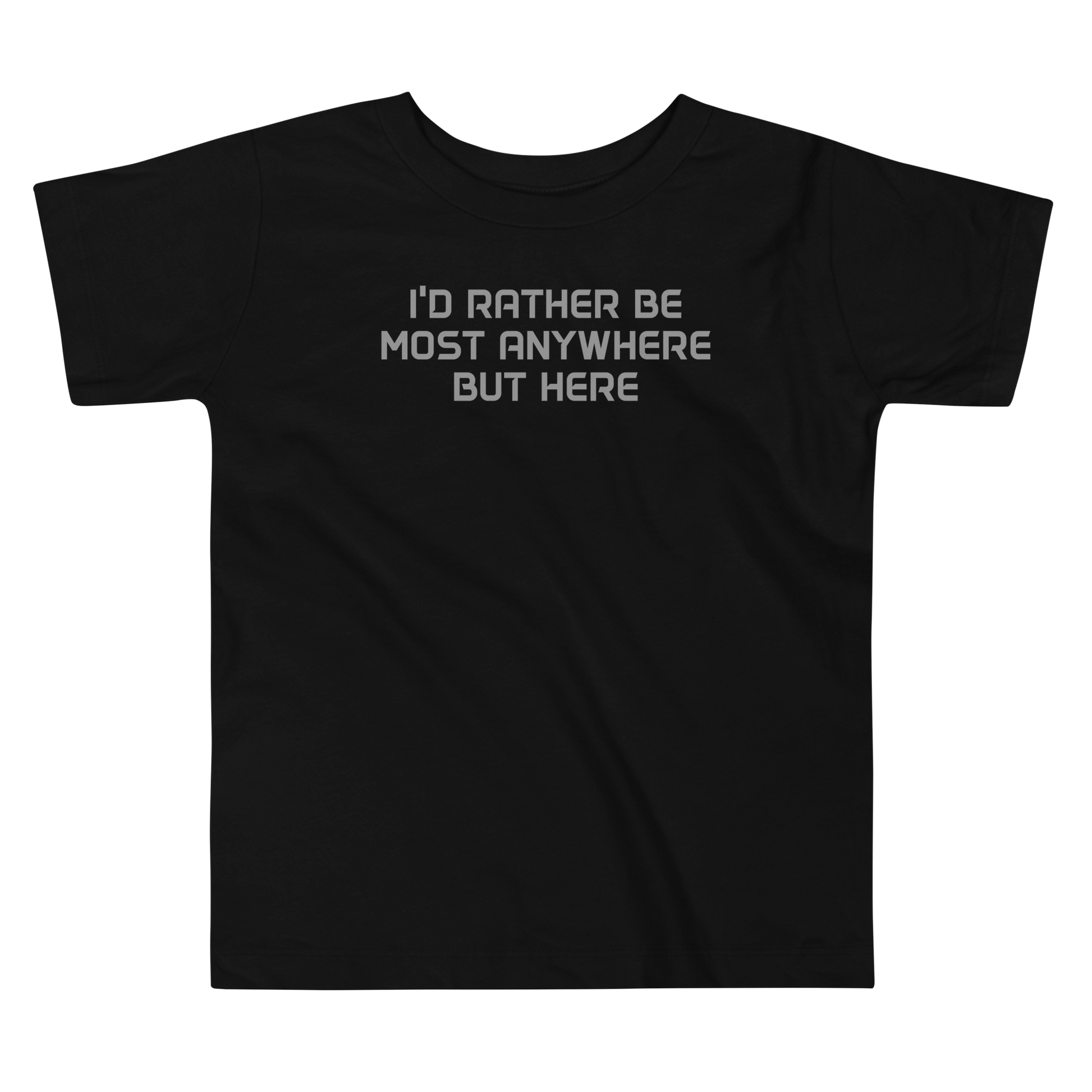 "I’d rather be most anywhere but here" printed on a black toddler short sleeve tee laying on a flat surface