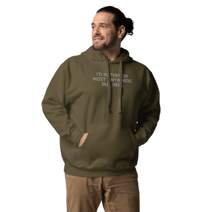 "I’d rather be most anywhere but here" printed on a military green unisex hoodie worn by a male