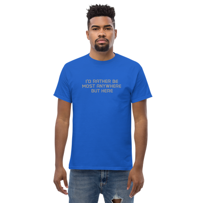 "I’d rather be most anywhere but here" printed on a royal unisex classic tee worn by a male